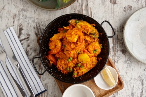Overhead view of seafood paella on table - Australian Stock Image