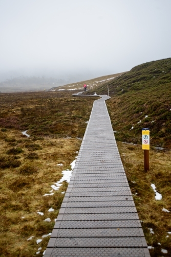 Misty boardwalk in Tasmania's Cradle mountain - Australian Stock Image