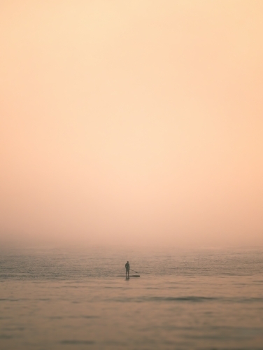 Paddleboarder in Heavy Fog on the Ocean