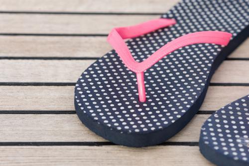 pair of blue thongs with hot pink band