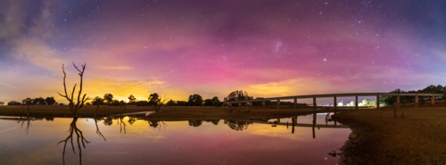 Panorama of Aurora Australia reflected in a river at Joyces Creek in Central Victoria - Australian Stock Image
