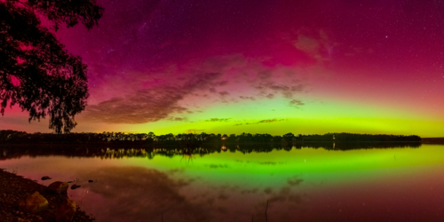 Panorama view of colourful Aurora Australias reflected on an inland lake - Australian Stock Image