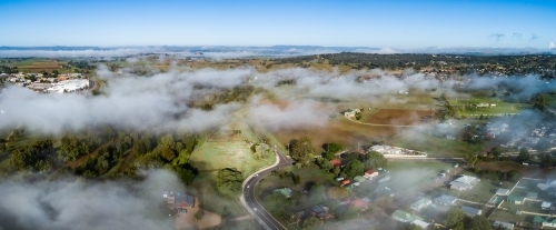 Panoramic landscape of cloud and mist covering Singleton in the early morning - Australian Stock Image