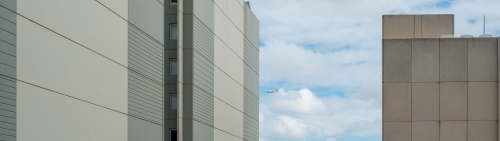 Panoramic of office buildings with cloudy sky behind