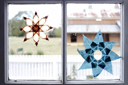 Paper stars stuck to window inside a farm house