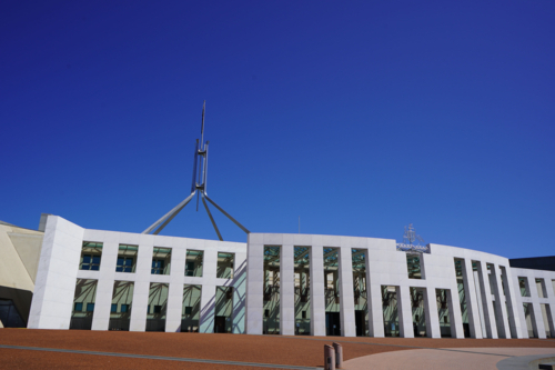 Parliament House under blue sky on bright day - Australian Stock Image