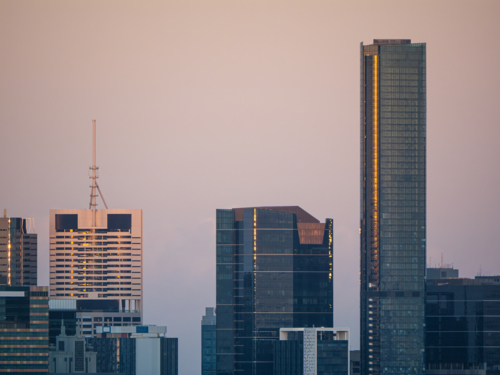Pastel coloured sky over city skyline. - Australian Stock Image