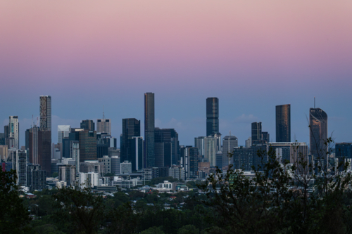 Pastel coloured sky over city skyline - Australian Stock Image