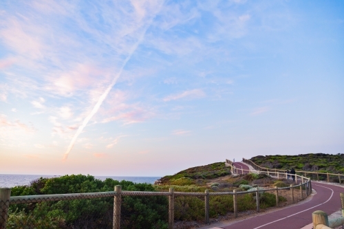Pastel dusk sky and walking trail along the coast in evening light