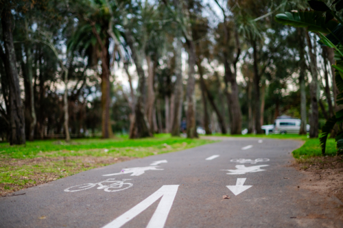 Pathway in a park shows signage for bike lane and pedestrian lane - Australian Stock Image