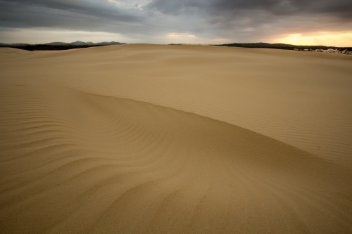 Patterns in sand dunes at sunrise - Australian Stock Image