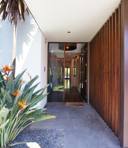 Paved and glass entrance to a contemporary home
