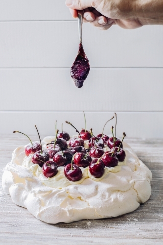 Pavlova topped with cherries