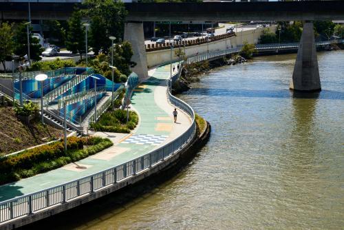 Pedestrians on the shared pathway beside the Brisbane River - Australian Stock Image