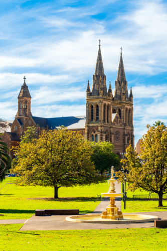 Pennington Gardens fountain with the St. Peters Cathedral in background in Adelaide on a day - Australian Stock Image