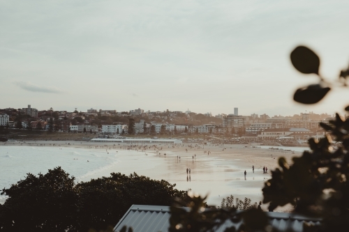 People enjoying a hazy sunset on Bondi Beach. - Australian Stock Image