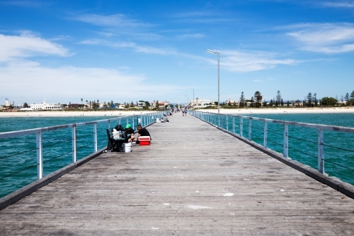 People fishing from jetty on a summer day - Australian Stock Image