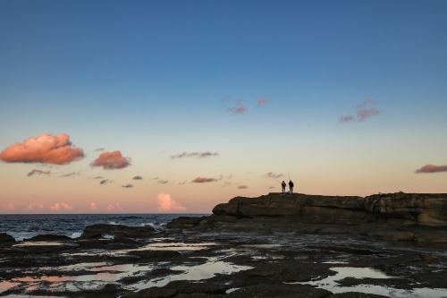 People fishing from rocks at Norah Head, New South Wales Australia - Australian Stock Image