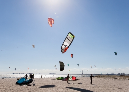 People kitesurfing at a city beach - Australian Stock Image