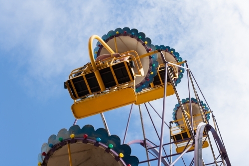 People on a ferris wheel at a city fun park