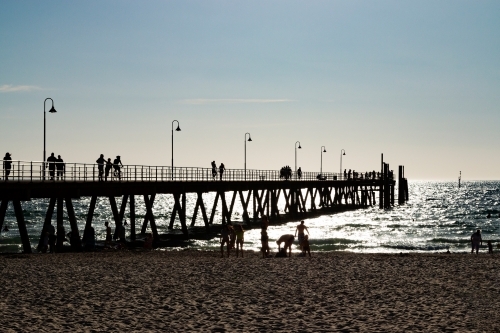 people on beach and jetty - Australian Stock Image