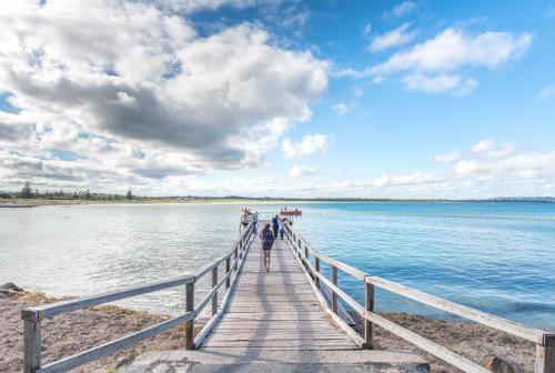 People on jetty by the sea