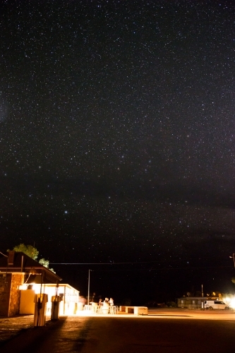 People outside hotel under starry sky - Australian Stock Image