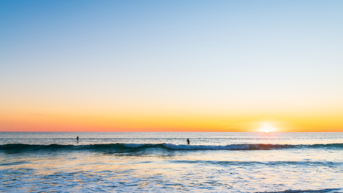 People paddleboarding at Southport beach, Port Noarlunga, South Australia - Australian Stock Image