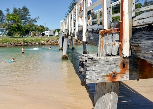 People paddling in coastal creek in holiday location - Australian Stock Image