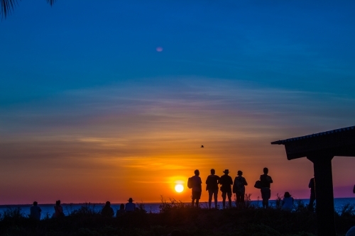 People silhouetted by the sunset - Australian Stock Image