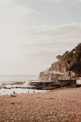 People swimming at the Bogey Hole and Bronte Ocean Pool (Bronte Baths) at sunrise vertical - Australian Stock Image