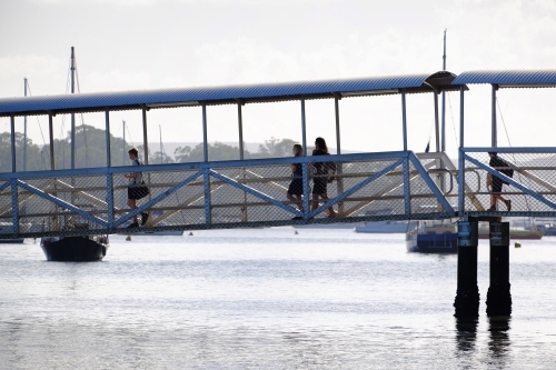 People walking on jetty at Karragarra Island - Australian Stock Image