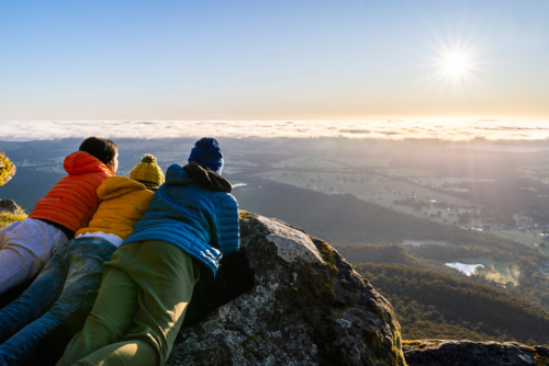 People watching the sunrise panorama from Boroka Lookout cliff at Grampians, Victoria, Australia - Australian Stock Image