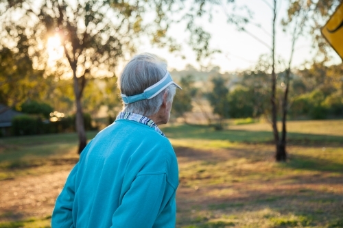 Person hiking through park in the early morning - Australian Stock Image