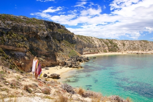 Person with beach towl watching the ocean in summer - Australian Stock Image