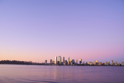 Perth City skyline at dusk across the Swan River - Australian Stock Image