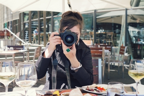 Photographer shooting a portrait of the viewer over lunch - Australian Stock Image