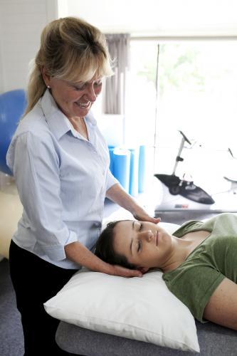 Physiotherapist treating female patient - Australian Stock Image