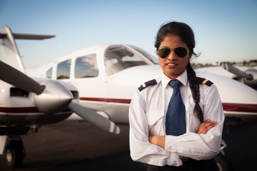 Pilot Standing Alongside Her Small Aircraft - Australian Stock Image