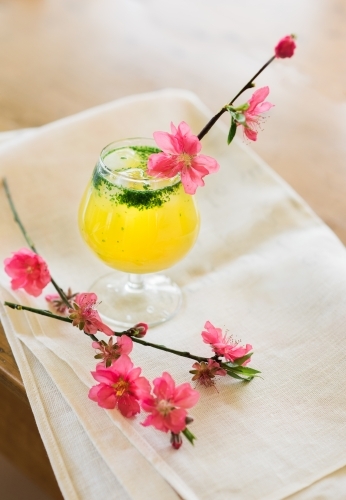 Pink cherry blossoms and cocktail with napkin