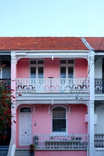 Pink house with white wrought iron décor