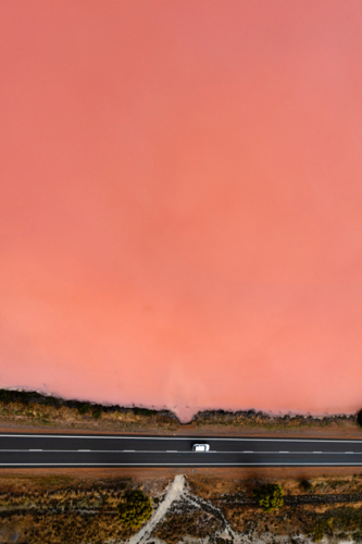 Pink Lake and road with car - Australian Stock Image