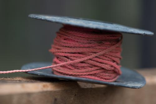 Pink string line resting on top of hardwood