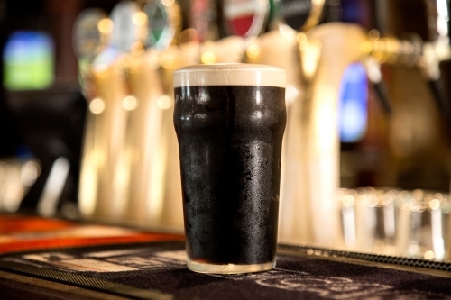 Pint of guinness on a bar - Australian Stock Image