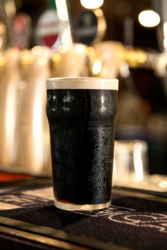 Pint of guinness on a bar - Australian Stock Image