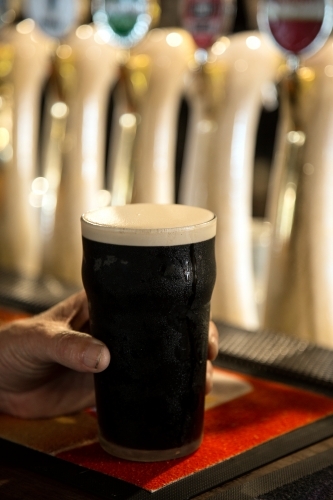 Pint of guinness on a bar - Australian Stock Image