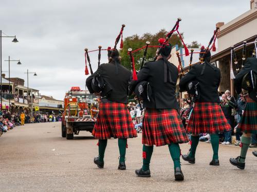Pipers marching along a street - Australian Stock Image