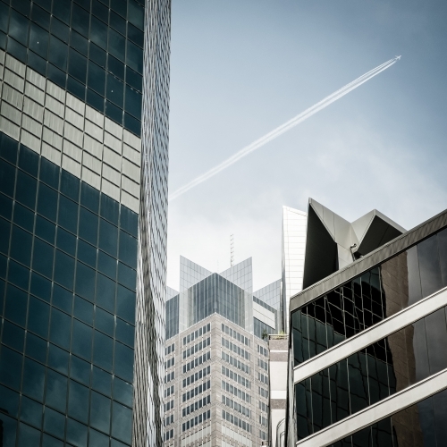 Plane flying over CBD - Australian Stock Image