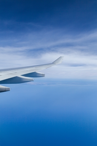 Plane wing over coastal Australian waters on long distance flight - Australian Stock Image