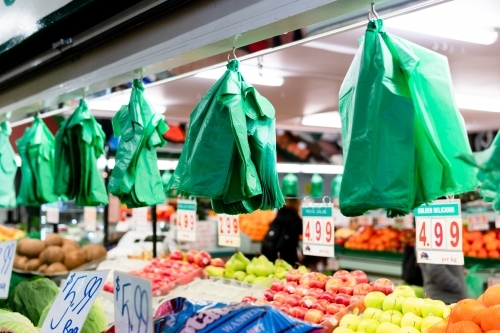 Plastic bags hanging on top of a food stall in the market. - Australian Stock Image